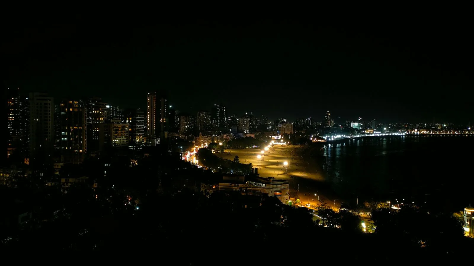 Mumbai's Marine Drive at night, curving along the water